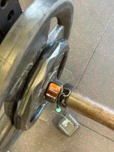 Apple Watch attached to a bar during a field test with a linear encoder