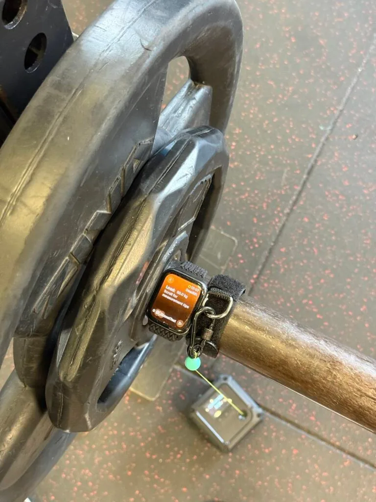 Apple Watch attached to a bar during a field test with a linear encoder